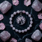 Pink beaded bracelet with tree pendant on a dark surface with rose petals and crystals